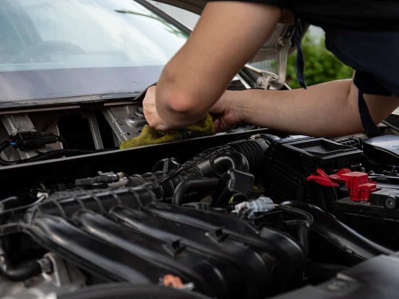 Mechanic servicing an engine in a Hampton Roads auto shop